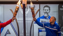 U.S. Air Force Senior Master Sgt. Aaron Lin, right, and a wounded warrior from the U.S. Marine Corps light the Wounded Warrior Trials cauldron during the opening ceremony at Joint Base San Antonio – Randolph, March 14, 2025. Lin shares his story of recovering from posttraumatic stress disorder through the help of leadership, his family, and the care of the Military Health System.