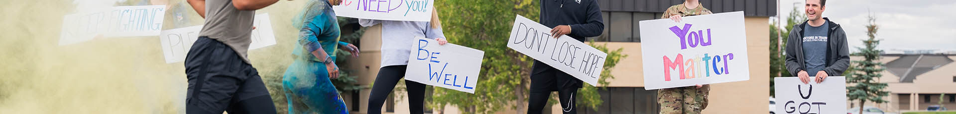 Members of the 341st Missile Wing cross the finish line while others hold signs of encouragement during a Suicide Awareness Color Run Sept. 9, 2022, at Malmstrom Air Force Base, Mont. Service members and civilians who feel a greater connection to their leadership and mission are less likely to be at risk for self-harm in times of distress. (U.S. Air Force photo by Heather Heiney)