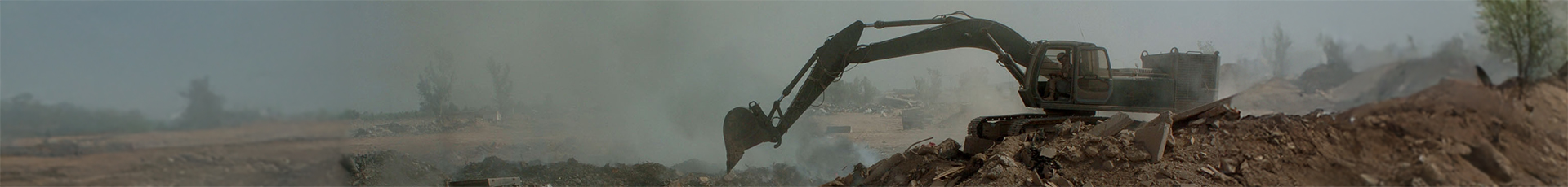 (LOGISTICS SUPPORT AREA ANACONDA, Balad, Iraq) - Soldiers from the 84th Combat Engineer Battalion use a bulldozer and excavator to manuever trash and other burnable items around in the burn pit at the landfill here. The bulldozer is primarily used to keep refuse constantly burning, and the excavator to push dirt over chutes to make the land useable in the future.
