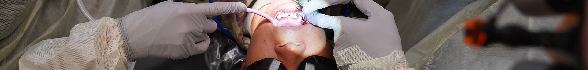 U.S. Air Force Col. Scott Wright, 81st Medical Group prosthodontist, and Amanda Kersey, 81st MDG dental assistant, examine the teeth of Airman 1st Class Diamond Bonner, 81st MDG dental assistant, at Keesler Air Force Base, Mississippi, Aug. 30, 2022. The primary mission of the 81st MDG is to maintain medical readiness for worldwide contingencies by providing health care for more than 22,000 enrollees, including almost 4,500 active-duty members. (U.S. Air Force photo by Airman 1st Class Elizabeth Davis)